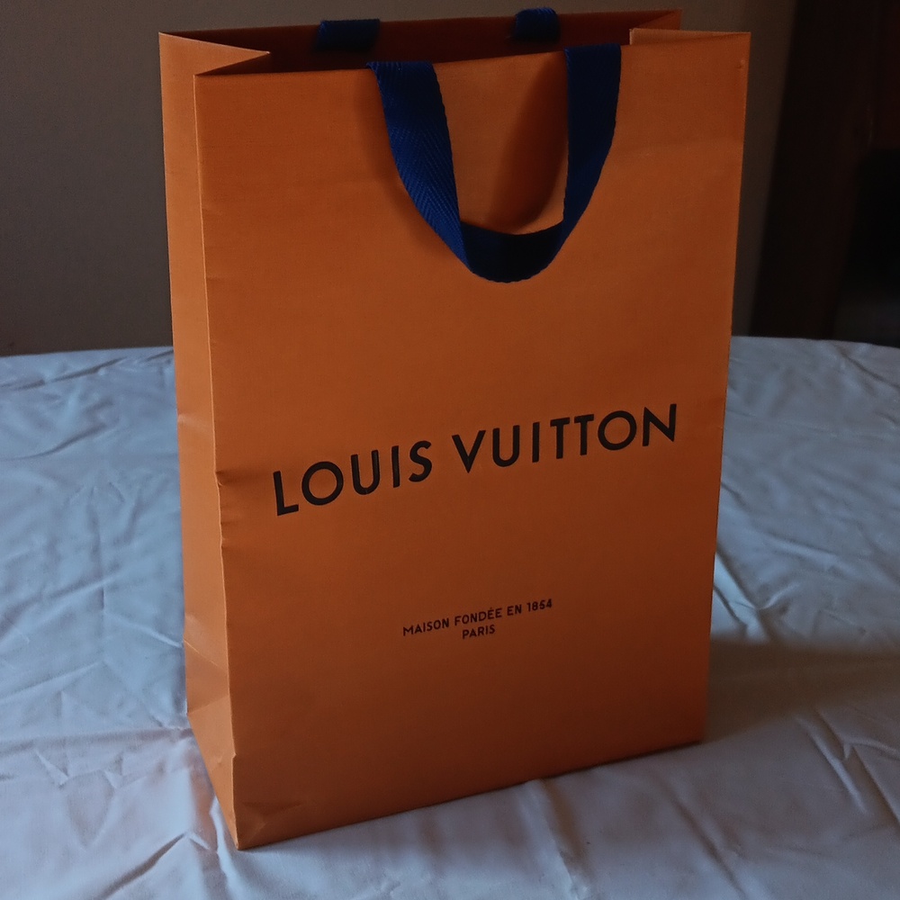 Louis Vuitton Bold Orange Bag with Blue Handles.